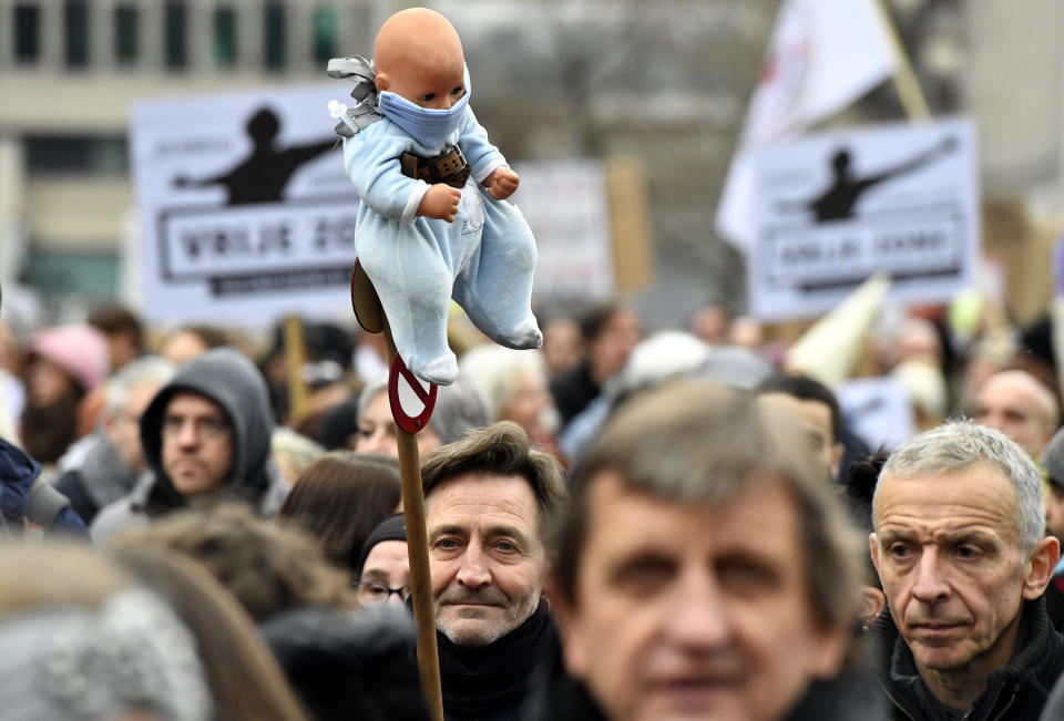 Demonstrators march during a protest against coronavirus measures in Brussels, Belgium, Sunday, Dec. 5, 2021. Hundreds of people marched through central Brussels on Sunday to protest tightened COVID-19 restrictions imposed by the Belgian government to counter the latest spike in coronavirus cases. (AP Photo/Geert Vanden Wijngaert)