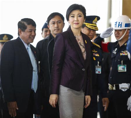 Thailand Prime Minister Yingluck Shinawatra (C) arrives at the Royal Thai Air Force headquarters before a cabinet meeting in Bangkok February 11, 2014. REUTERS/Athit Perawongmetha