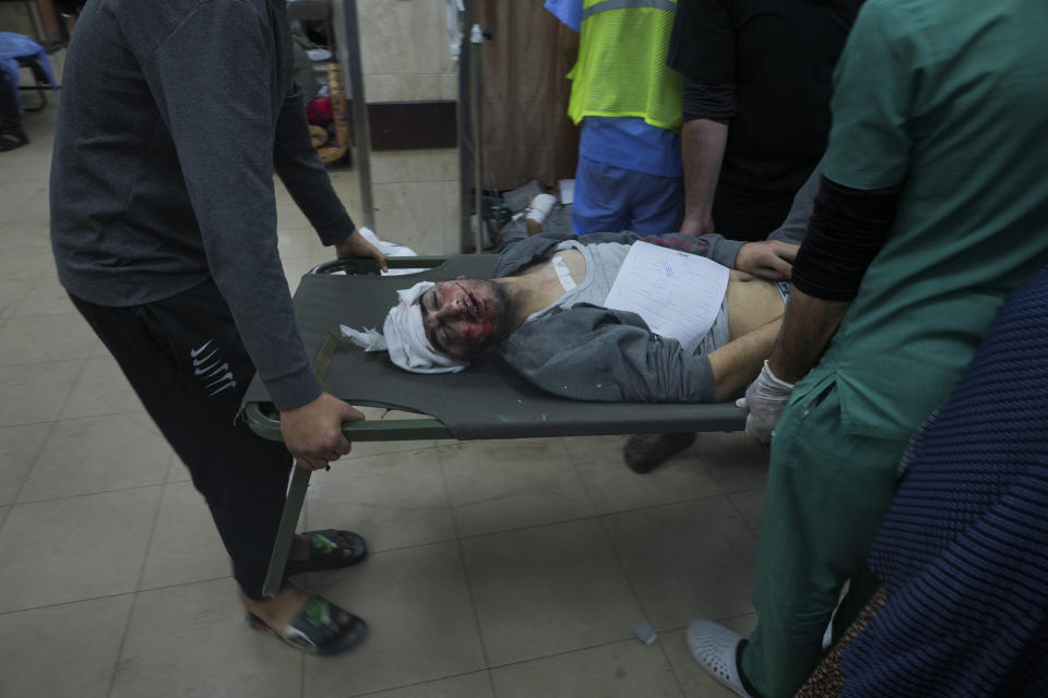 Palestinians wounded in the Israeli bombardment of the Gaza Strip are brought to the hospital in Deir al Balah on Sunday, Dec. 3, 2023. (AP Photo/ Hatem Moussa)