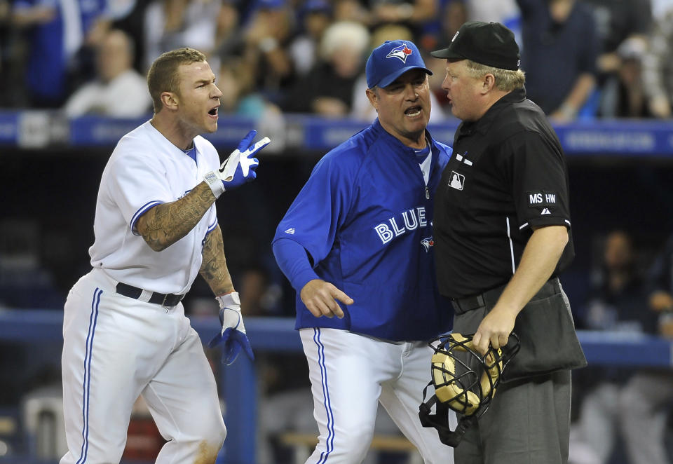 TORONTO, CANADA - MAY 15: Brett Lawrie #13 and Manager John Farrell of the Toronto Blue Jays argue a call with Umpire Bill Miller during MLB game action against the Tampa Bay Rays May 15, 2012 at Rogers Centre in Toronto, Ontario, Canada. (Photo by Brad White/Getty Images)