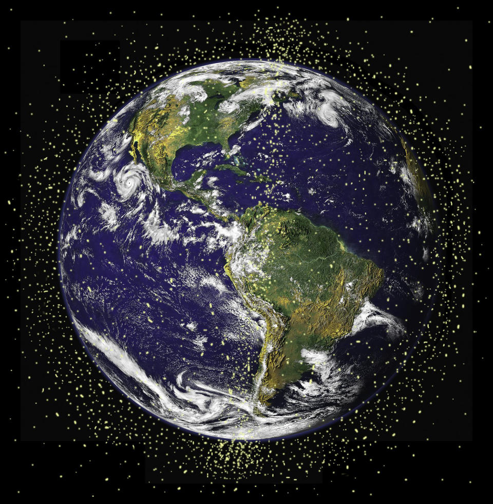 An artist's depiction of orbiting debris and satellites around Earth. (NASA)