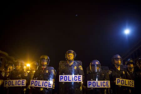 Police line up shortly after the deadline for a city-wide curfew at North Ave and Pennsylvania Ave in Baltimore, Maryland April 30, 2015. REUTERS/Eric Thayer