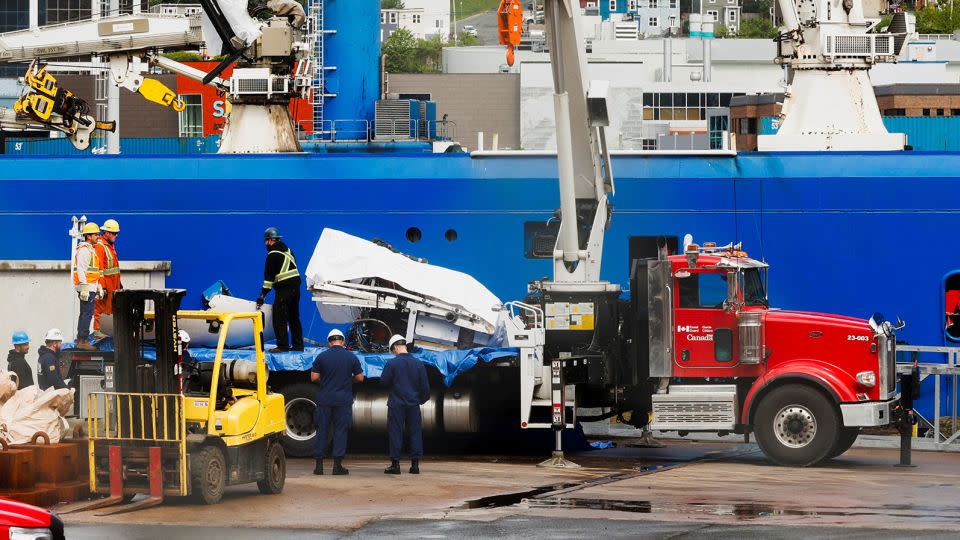 Salvaged pieces of the Titan submersible from OceanGate Expeditions arrive Wednesday in St. John's, Newfoundland and Labrador, via the Horizon Arctic ship. - David Hiscock/Reuters