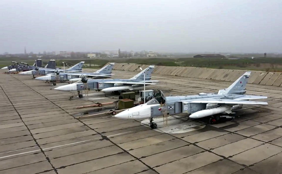 FILE - This photo released by Russian Defense Ministry Press Service, shows Russian Su-24 bombers parked at an air base in Crimea in preparation for maneuvers. Ukrainian and Western officials are worried that a Russian military buildup near Ukraine could signal plans by Moscow to invade its ex-Soviet neighbor. The Kremlin insists it has no such intention and has accused Ukraine and its Western backers of making the claims to cover up their own allegedly aggressive designs. (Russian Defense Ministry Press Service via AP, File)