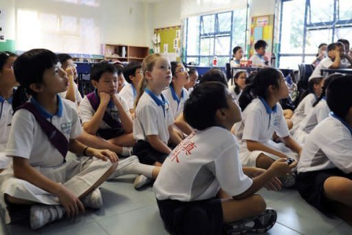 Happy Rogers (C) listens attentively to her Chinese teacher in her Mandarin class at Nanyang Primary School in Singapore in May 2012. Rogers's parents are among the growing ranks of Western parents keen to prepare their children for the "Chinese Century"