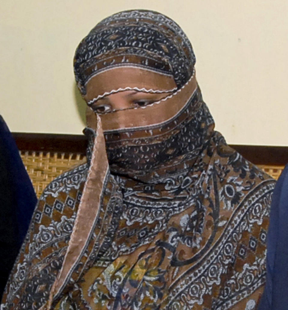 FILE - In this Nov. 20, 2010, file photo, Aasia Bibi, a Pakistani Christian woman, listens to officials at a prison in Sheikhupura near Lahore, Pakistan. In Mid January 2019, the Pakistani Christian woman still lives the life of a prisoner, although she was freed from death row by the country’s top court more than two months ago. Meanwhile, a petition by Islamist radicals who rallied against her acquittal of blasphemy charges and who seek her execution awaits a Supreme Court decision. (AP Photo, File)