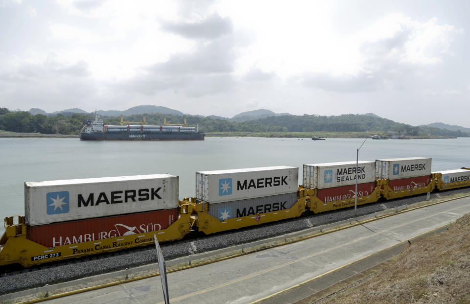 In this Feb. 25, 2019, photo, a Panama Canal railway train transport containers from the Atlantic to the Pacific Ocean alongside the Panama Canal in Gamboa, Panama. China’s expansion in Latin America of its Belt and Road initiative to build ports and other trade-related facilities is stirring anxiety in Washington. As American officials express alarm at Beijing’s ambitions in a U.S.-dominated region, China has launched a charm offensive, wooing Panamanian politicians, professionals, and journalists. (AP Photo/Arnulfo Franco)