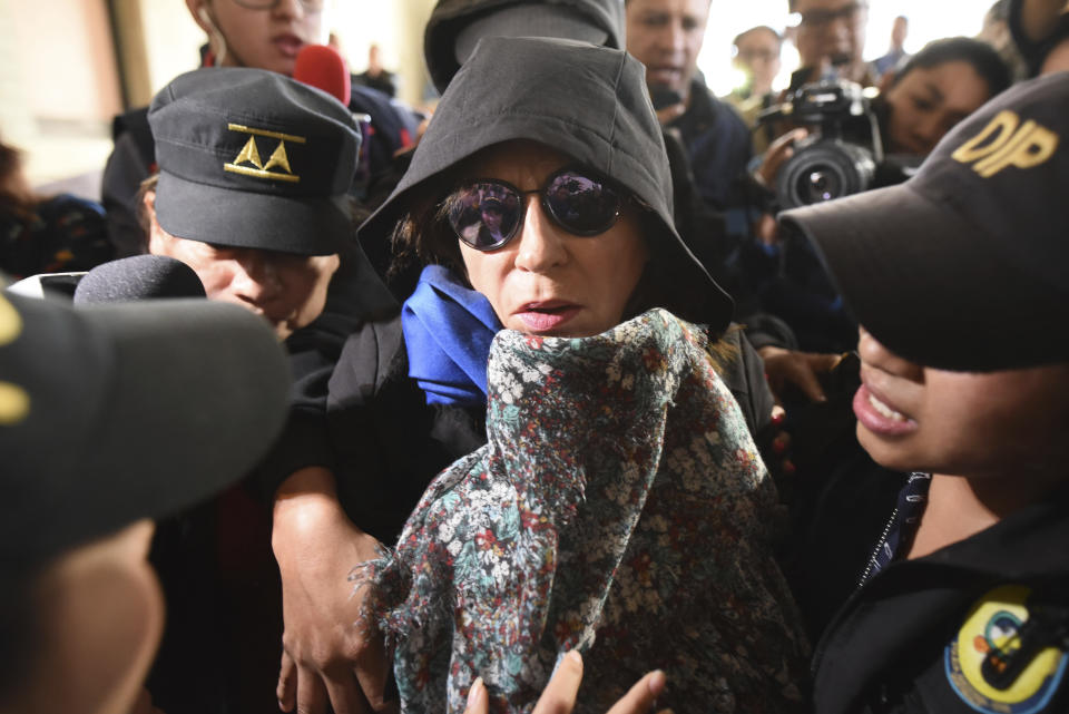 Former first lady and former presidential candidate Sandra Torres is escorted by police to the Supreme Court in Guatemala City, Monday, Sept. 2, 2019. Authorities arrested Torres at her home on charges of campaign finance violations. (AP Photo/Oliver De Ros)