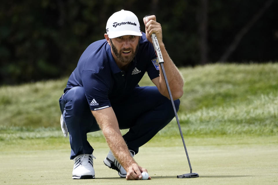 Dustin Johnson lines his putt on the first green during the final round of the BMW Championship golf tournament at the Olympia Fields Country Club in Olympia Fields, Ill., Sunday, Aug. 30, 2020. (AP Photo/Charles Rex Arbogast)