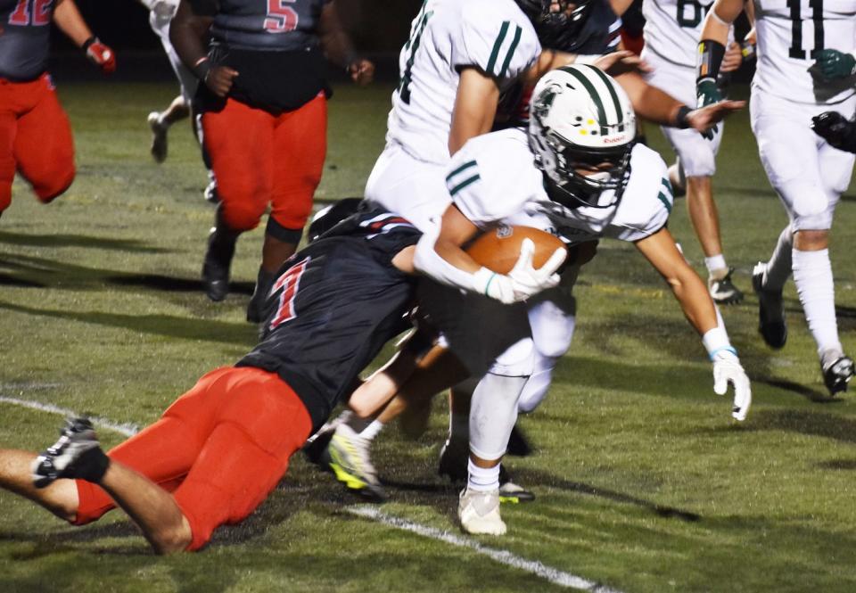 Durfee's Dabriel Monteiro (7) goes in for the tackle against Dartmouth's Markus Andrews (13).