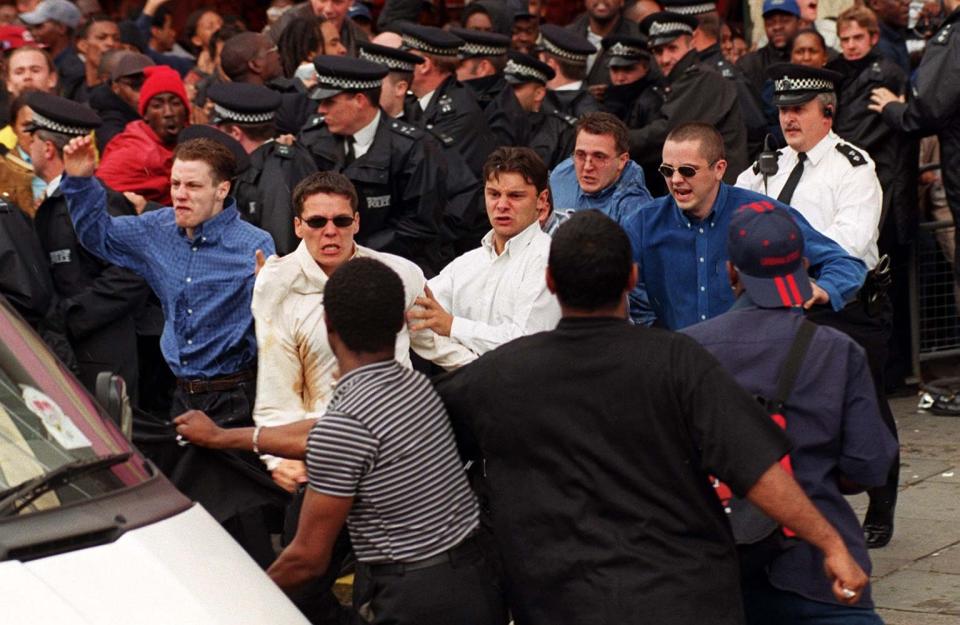 The violent scenes outside the inquiry. Acourt is in a white shirt and sunglasses (PA)