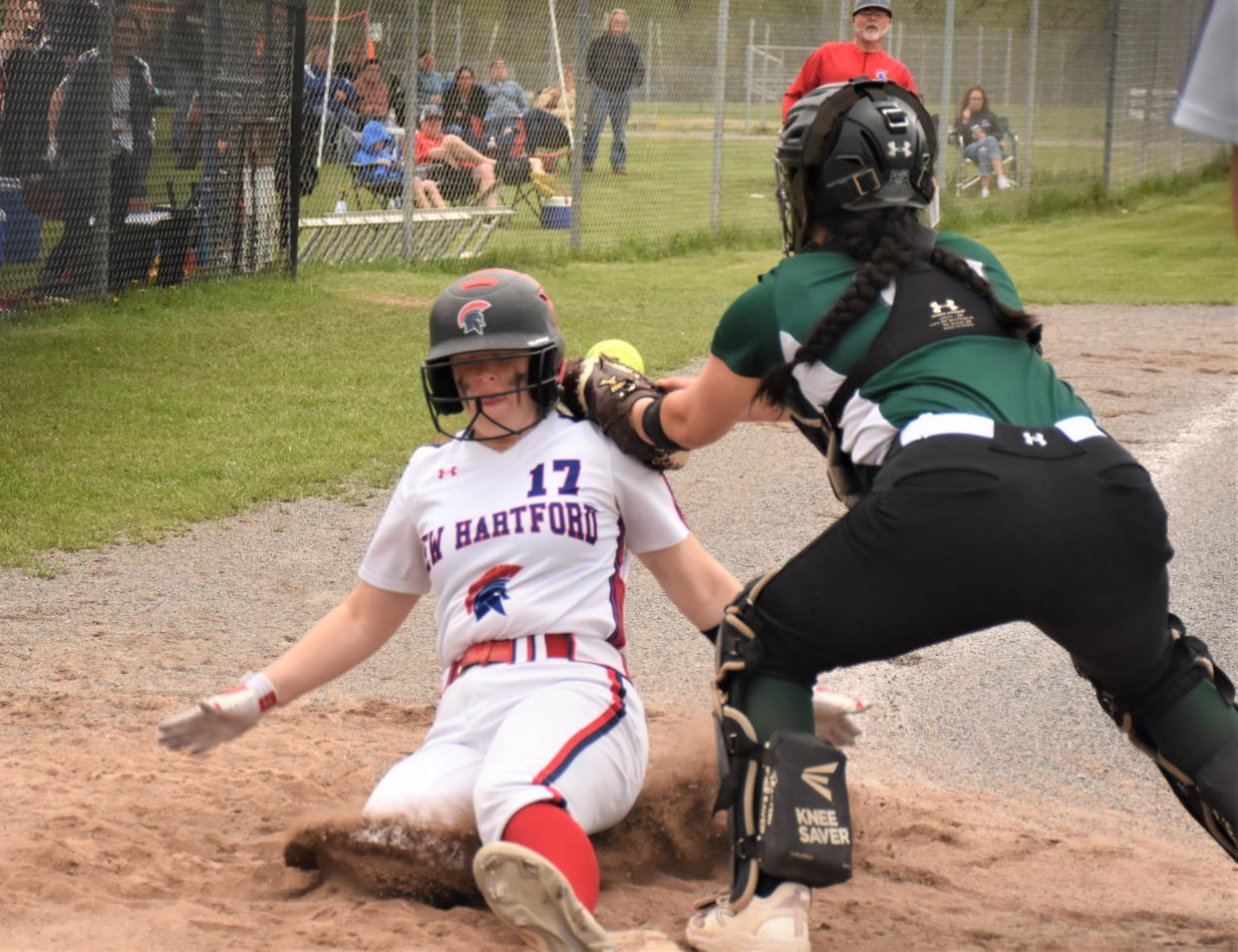 New Hartford Spartan Taylor Scranton (17) slides home safely Saturday as the throw reaches the plate at Mudville during an Officer Joe Corr Tournament game against Buffalo's Nichols School.