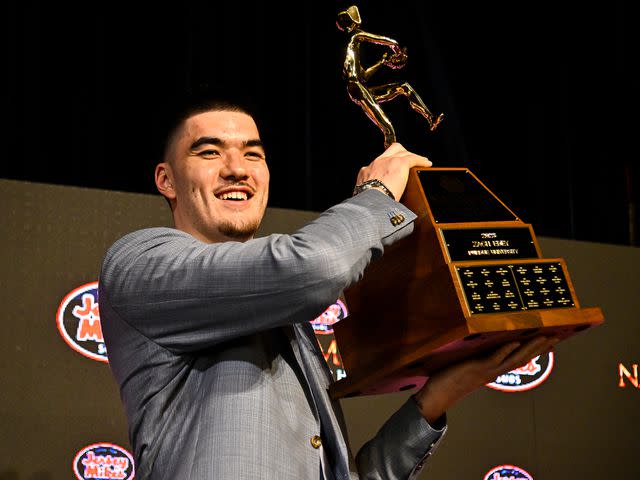 <p>Logan Riely/Getty</p> Zach Edey is presented with the Naismith Men's College Player of the Year trophy during the 2023 Naismith Hall of Fame Brunch on April 02, 2023 in Houston, Texas.