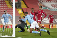 Manchester City's Raheem Sterling, foreground, scores his side's third goal during the English Premier League soccer match between Liverpool and Manchester City at Anfield Stadium, Liverpool, England, Sunday, Feb. 7, 2021. (AP photo/Jon Super, Pool)