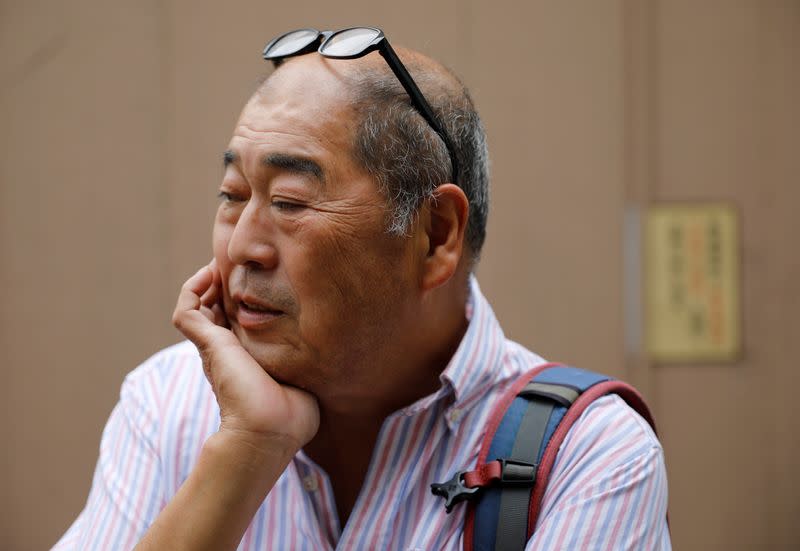 Fumiaki Ichiyama who managed Yonosuke that closed the business this spring, watches the site where his bar was located amid the coronavirus disease (COVID-19) outbreak, in Tokyo