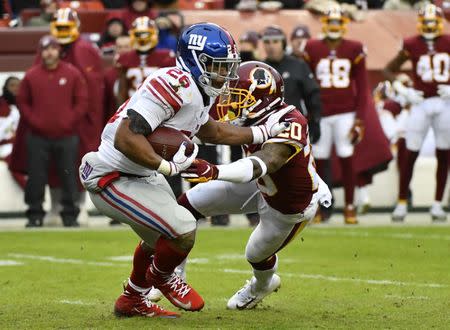 Dec 9, 2018; Landover, MD, USA; New York Giants running back Saquon Barkley (26) is tackled by Washington Redskins safety Ha Ha Clinton-Dix (20) during the second half at FedEx Field. Brad Mills-USA TODAY Sports