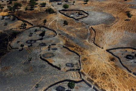 FILE PHOTO: An aerial view shows the remains of burnt homes from what residents said was the latest attack by armed men in Thonyor, Leer County, South Sudan February 23, 2017. REUTERS/Siegfried Modola/File Photo