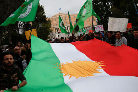 Kurds living in Greece hold a giant Kurdish flag and shout slogans during a demonstration against the Turkish offensive on Kurdish forces in northwest Syria, in Athens, Greece, January 23, 2018. REUTERS/Alkis Konstantinidis