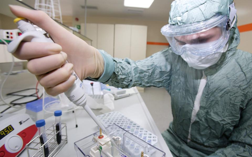 A GSK scientist works on vaccines for swine flu - Reuters