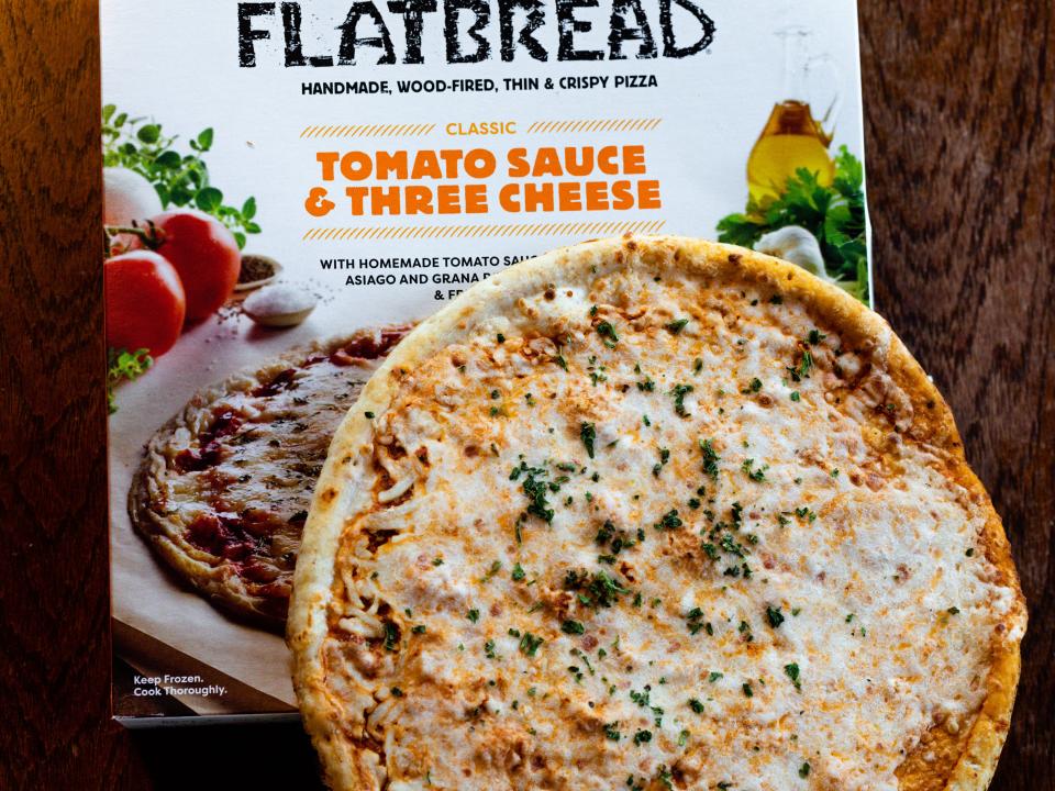 America's Flatbread pizza box with pizza on top