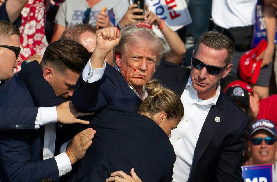 Republican candidate Donald Trump is seen with blood on his face surrounded by secret service agents as he is taken off the stage at a campaign event at Butler Farm Show Inc. in Butler, Pennsylvania, July 13, 2024. Donald Trump was hit in the ear in an apparent assassination attempt by a gunman at a campaign rally on Saturday. Sunday, Mississippi State Auditor Shad White called for U.S. Congressman Bennie Thompson to resign after one of his staffers posted support for the would be assassin.