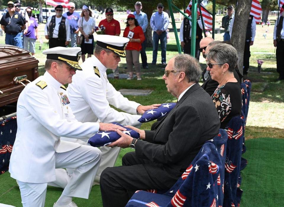 American flags are presented to family of Seaman 2nd Class Denver True “D.T.” Kyser, as he is finally laid to rest at Fresno Memorial Gardens Saturday afternoon, May 21, 2022 in Fresno. Kyser’s remains were identified recently through modern DNA technology. Kyser, 18 at the time, was assigned to and serving on the battleship USS Oklahoma when it was attacked by Japanese aircraft while moored at Ford Island, Pearl Harbor on Dec. 7, 1941.