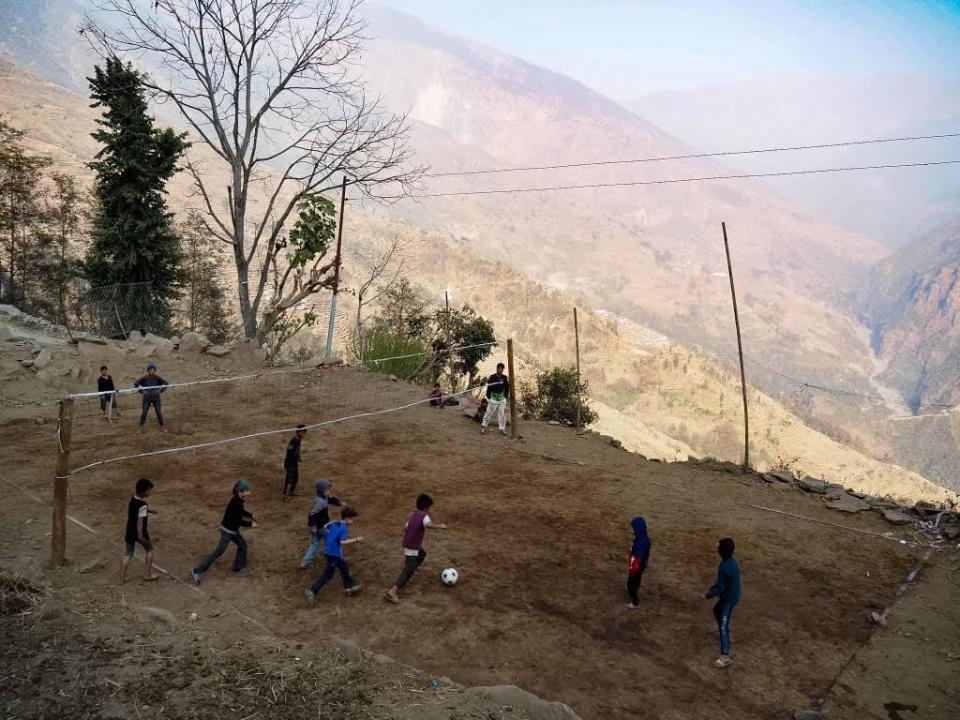 The Lemay-Pelletier family play soccer with local children in Ghormu, a Nepalese village.