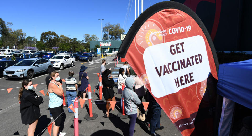 People queue to receive a Covid-19 vaccine at a Bunnings hardware store on October 16, 2021 in Brisbane. Source: Getty Images