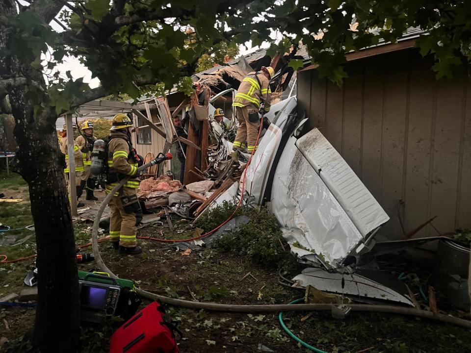 Two people were killed and and another sustained injuries after a small airplane crashed through the roof of a home in northwestern Oregon on Tuesday night, authorities said.  / Credit: Tualatin Valley Fire and Rescue / Facebook