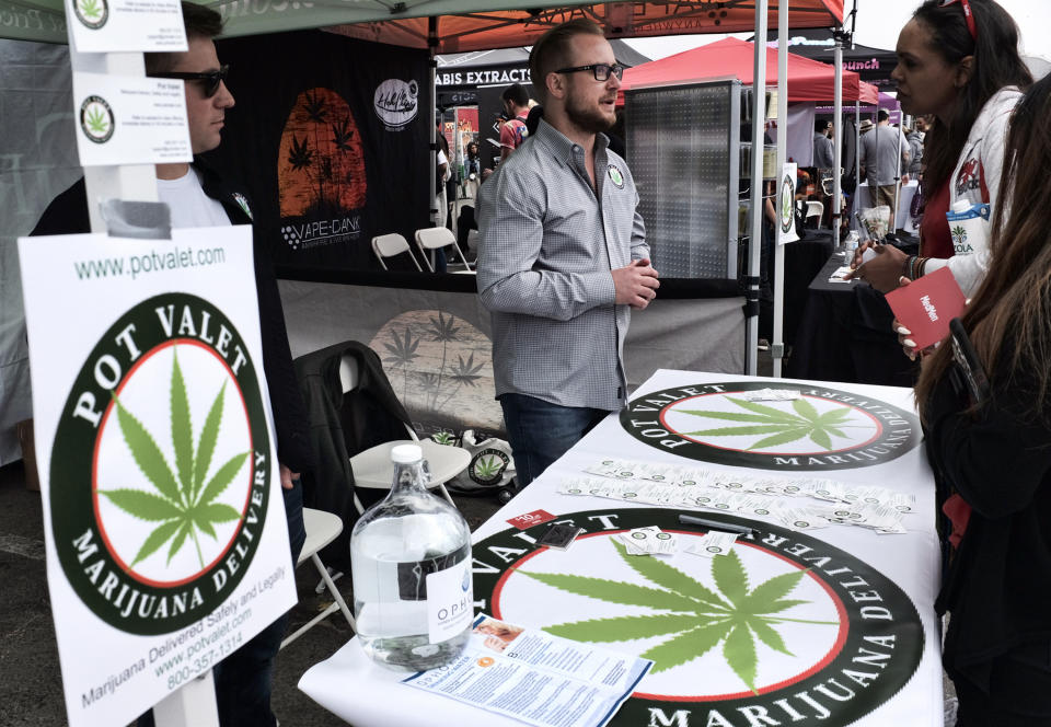 FILE - This March 31, 2018 photo shows a booth advertising a delivery service for cannabis at the Four Twenty Games in Santa Monica, Calif. California has endorsed a rule that will allow home marijuana deliveries statewide, even into communities that have banned commercial pot sales. The rule finalized Wednesday, Jan. 16, 2019 by state officials was opposed by police chiefs and other critics who say it will create an unruly market of largely hidden pot transactions and encourage potential criminal activity. (AP Photo/Richard Vogel, File)