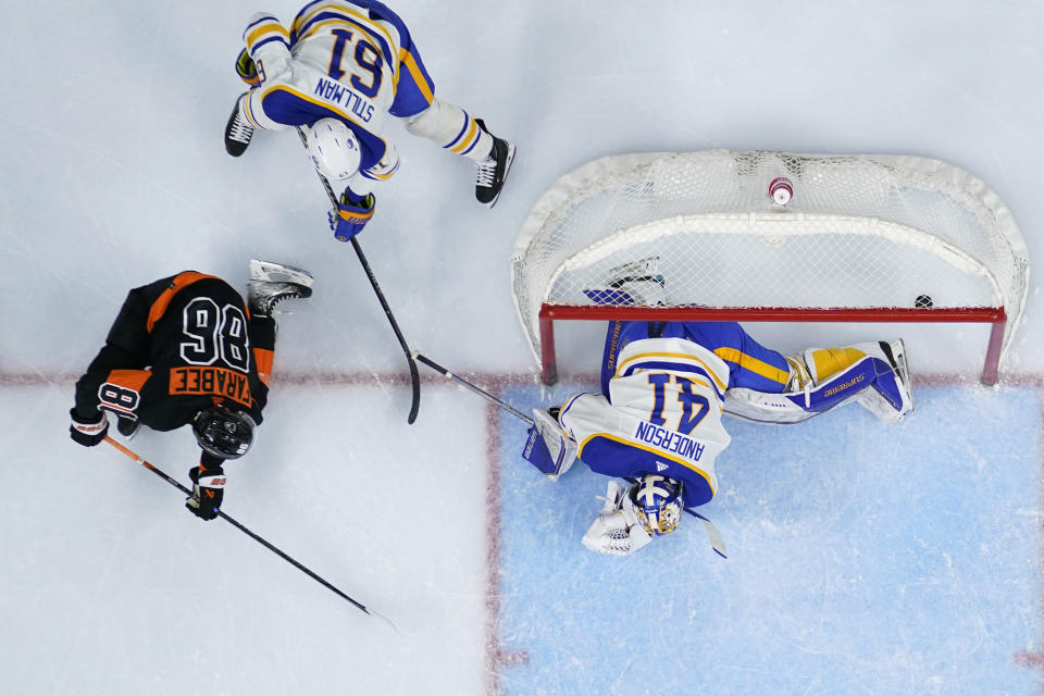 Philadelphia Flyers' Joel Farabee (86) scores a goal past Buffalo Sabres' Craig Anderson (41) and Riley Stillman (61) during the second period of an NHL hockey game, Friday, March 17, 2023, in Philadelphia. (AP Photo/Matt Slocum)