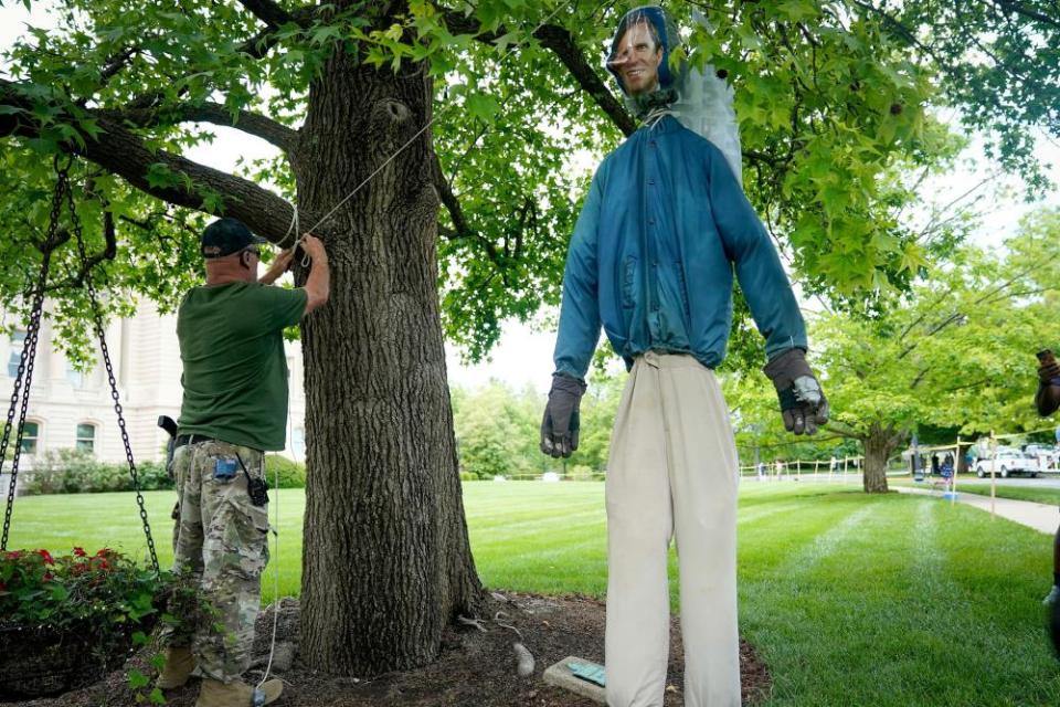 A demonstrator hangs an effigy of the Kentucky governor, Andy Beshear, during the rally.