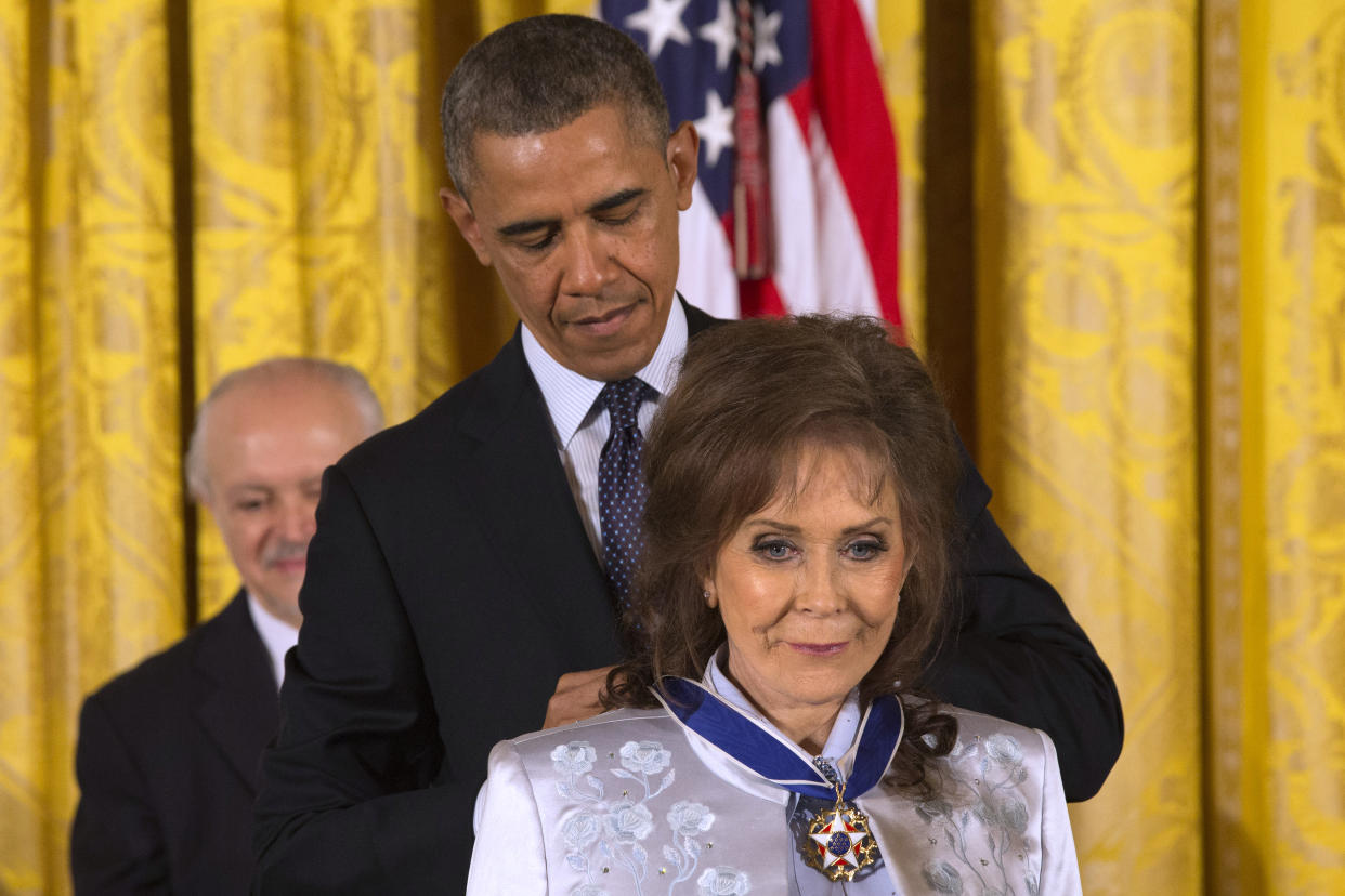 FILE - President Barack Obama awards country music legend Loretta Lynn with the Presidential Medal of Freedom, Wednesday, Nov. 20, 2013, during a ceremony in the East Room of the White House in Washington. Lynn, the Kentucky coal miner’s daughter who became a pillar of country music, died Tuesday at her home in Hurricane Mills, Tenn. She was 90. (AP Photo/Jacquelyn Martin, File)