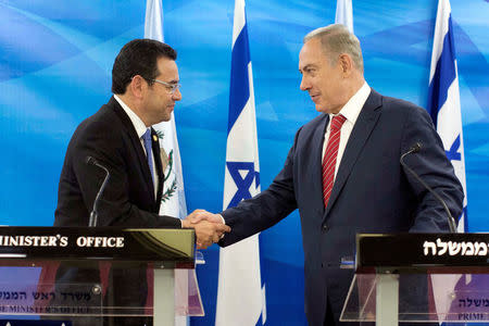 FILE PHOTO: Guatemalan President Jimmy Morales and Israeli Prime Minister Benjamin Netanyahu shake hands as they deliver statements to the media during their meeting in Jerusalem November 29, 2016. REUTERS/Abir Sultan/File Photo