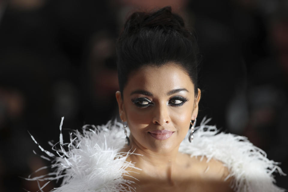 FILE- In this May 20, 2019 file photo, Aishwarya Rai Bachchan poses for photographers upon arrival at the premiere of the film 'La Belle Epoque' at the 72nd international film festival, Cannes, southern France. Bollywood superstar Amitabh Bachchan, his son and two other family members including Aishwarya Rai Bachchan have tested positive for the coronavirus in Mumbai, India’s financial and entertainment capital, a government minister said Sunday. (AP Photo/Petros Giannakouris, File)