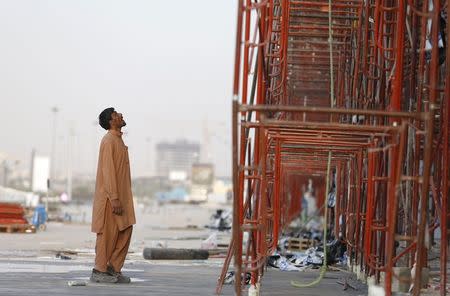 An Indian labourer looks at the construction site of a building in Riyadh November 16, 2014. REUTERS/Faisal Al Nasser