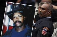 <p>Retired New York firefighter Bruce Stanley carries a photograph of fellow firefighter Liam Smith Jr. during a ceremony, Tuesday, Sept. 11, 2018, in New York, at the World Trade Center, marking the 17th anniversary of the terrorist attacks on the United States. Smith was one of 343 members of the fire department who were killed on Sept. 11, 2001. (AP Photo/Mark Lennihan) </p>