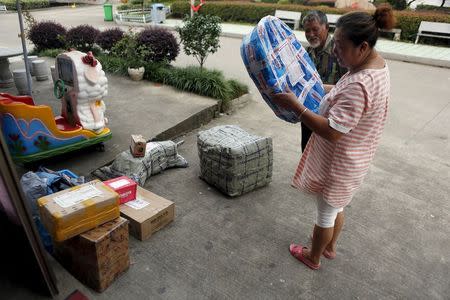 A customer checks on a parcel at an Alibaba rural service centre in Jinjia Village, Tonglu, Zhejiang province, China, July 20, 2015. REUTERS/Aly Song