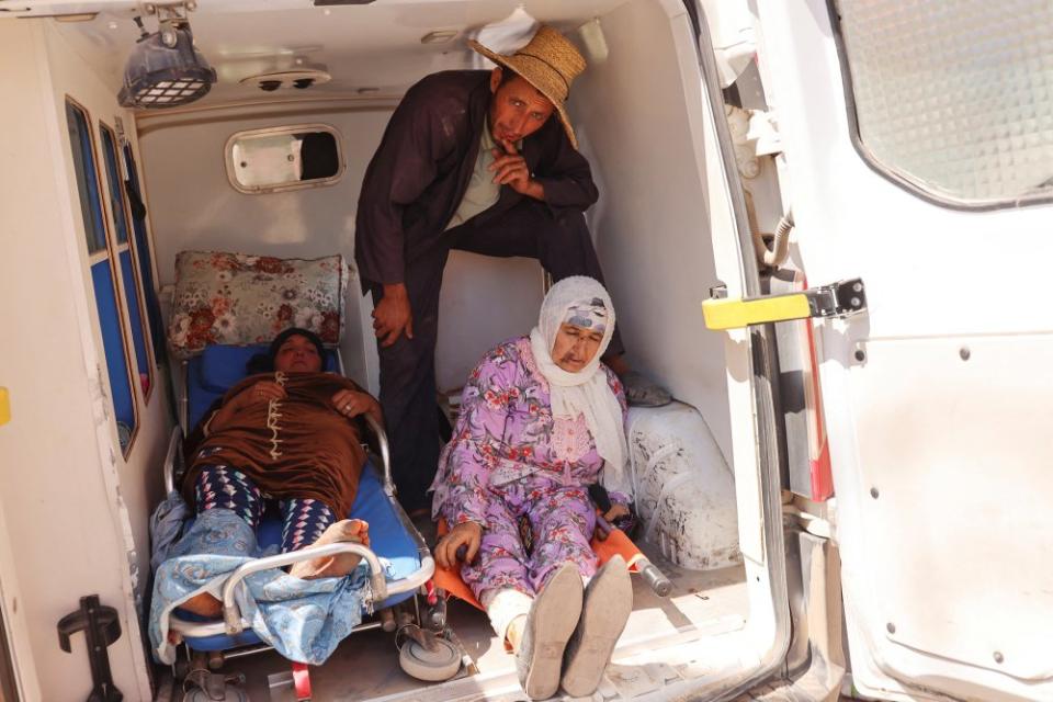 A man looks on, next to women who were rescued, in the back of an ambulance, in the aftermath of a deadly earthquake, in Amizmiz, Morocco, Sept. 10.<span class="copyright">Nacho Doce—Reuters</span>