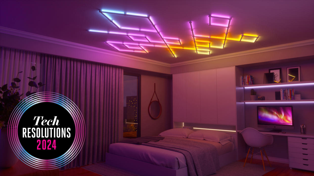  The Nanoleaf Lines, brightly coloured lights, mounted on the ceiling of a bedroom, casting a pink and orange glow on the room. 