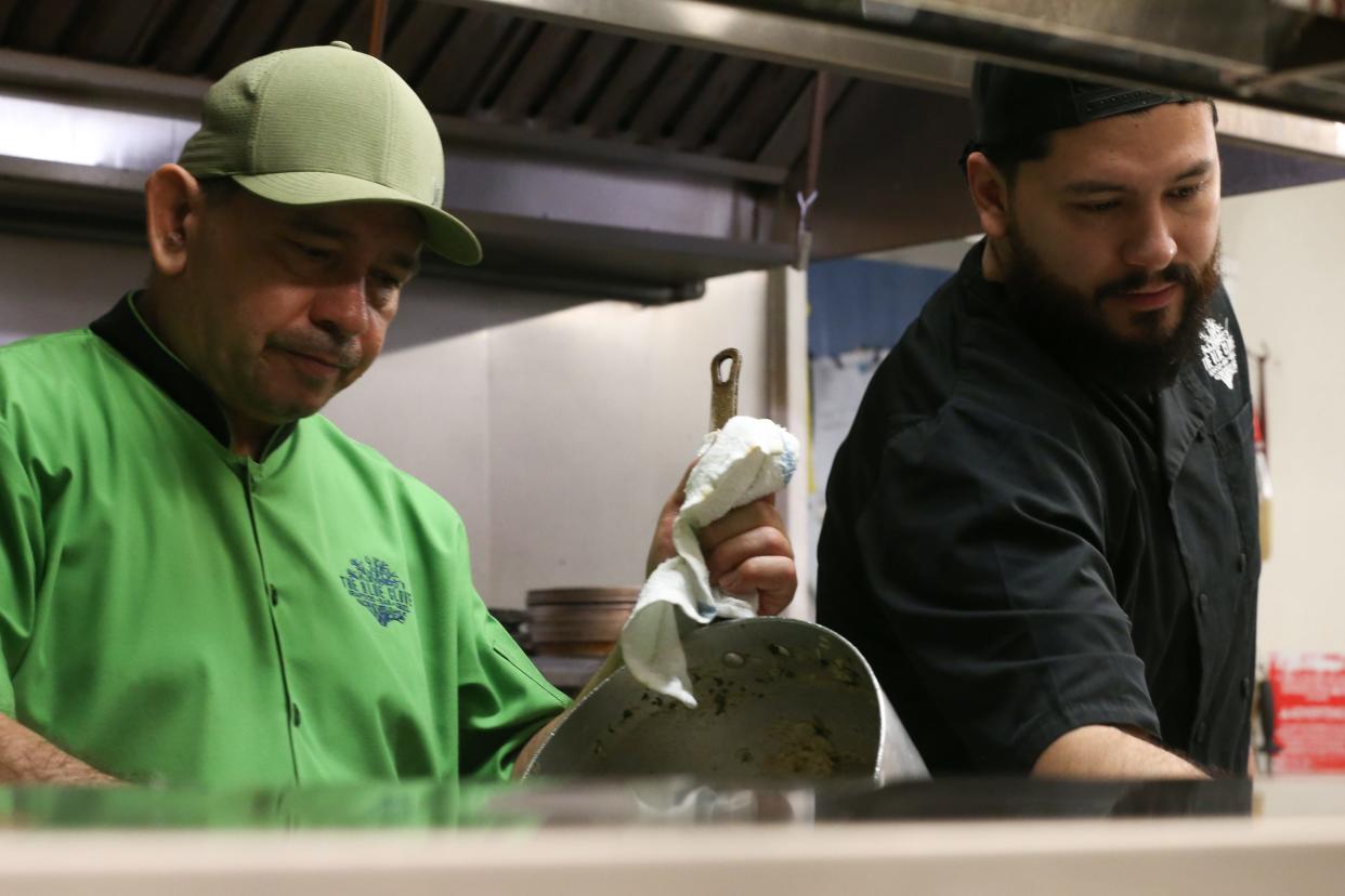From left, owners Antonio Posada and Antonio "Tony" Posada Jr. prep food before opening at The Blue Clove Seafood Bar and Grill in The Market on Everhart Friday, May 3, 2024.
