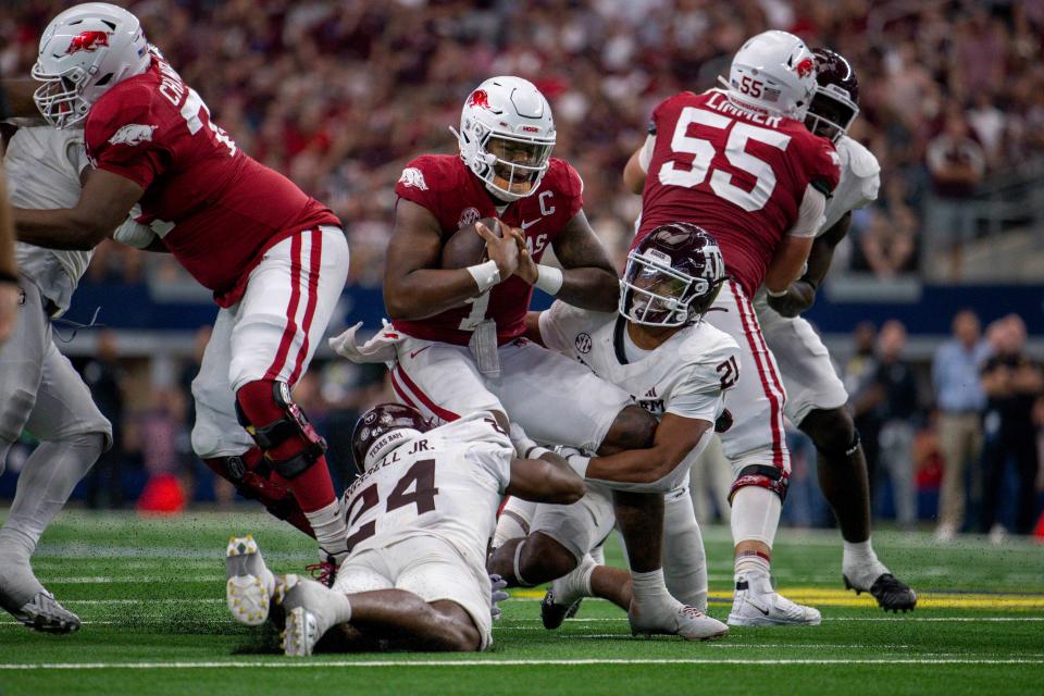 Sep 30, 2023; Arlington, Texas, USA; Texas A&M Aggies linebacker Chris Russell Jr. (24) and linebacker Taurean York (21) sack Arkansas Razorbacks quarterback KJ Jefferson (1) during the second half at AT&T Stadium. Mandatory Credit: Jerome Miron-USA TODAY Sports