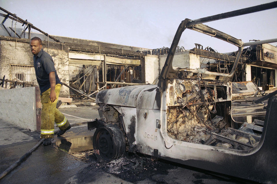 Firefighter walking through wreckage