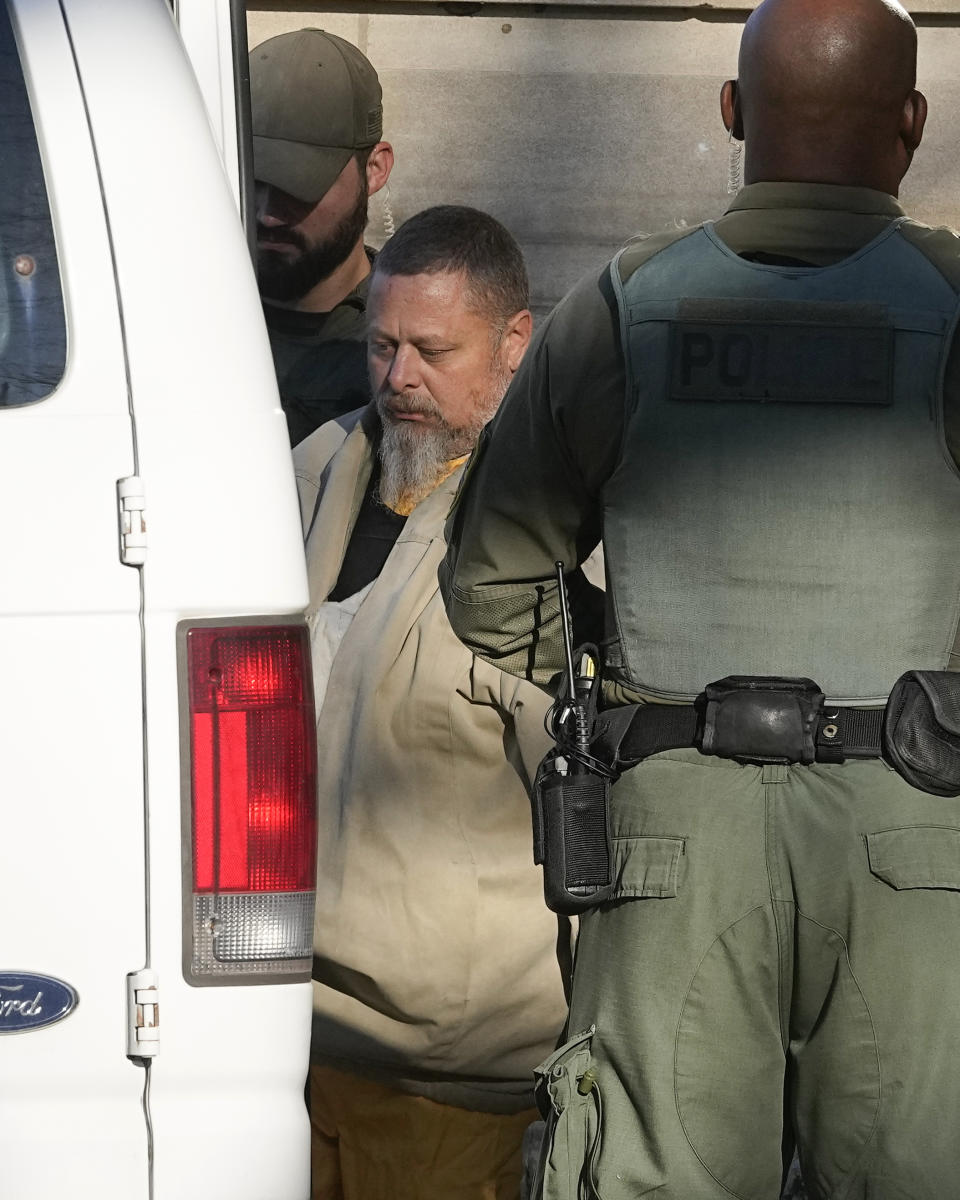 Officers escort Richard Matthew Allen, out of the Carroll County courthouse following a hearing, Tuesday, Nov. 22, 2022, in Delphi, Ind. Allen was charged last month with two counts of murder in the killings of Liberty German, 14, and Abigail Williams, 13. (AP Photo/Darron Cummings)