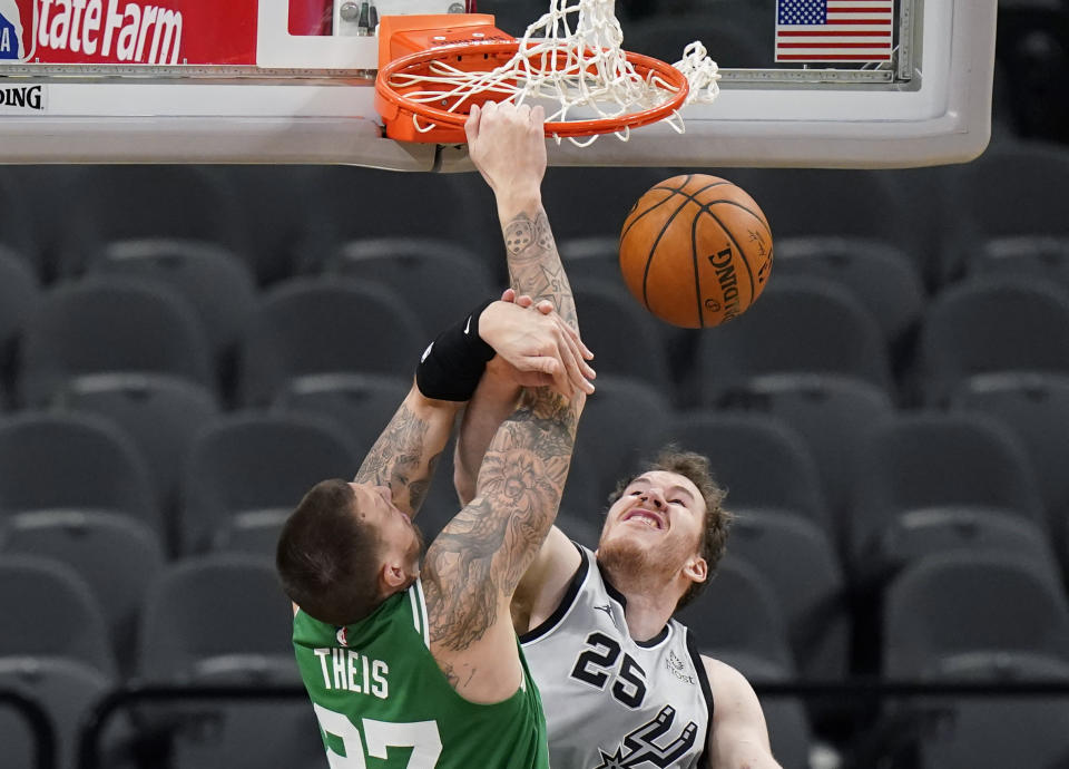 Boston Celtics center Daniel Theis (27) scores over San Antonio Spurs center Jakob Poeltl (25) during the second half of an NBA basketball game in San Antonio, Wednesday, Jan. 27, 2021. (AP Photo/Eric Gay)