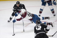 Colorado Avalanche right wing Mikko Rantanen, center, shoots over a reach by Los Angeles Kings defenseman Matt Roy, top, during the second period of an NHL hockey game Tuesday, Jan. 19, 2021 in Los Angeles. (AP Photo/Kyusung Gong)