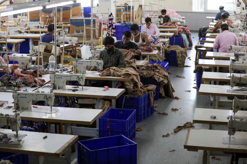 Workers stitch garments at a factory of an apparel shop in Jaipur