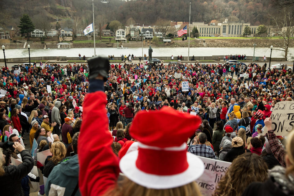 <p>Teachers and demonstrators hold signs and chant during a rally outside the West Virginia Capitol in Charleston, W.Va. on Friday, March 2, 2018. (Photo: Scott Heins/Bloomberg via Getty Images) </p>