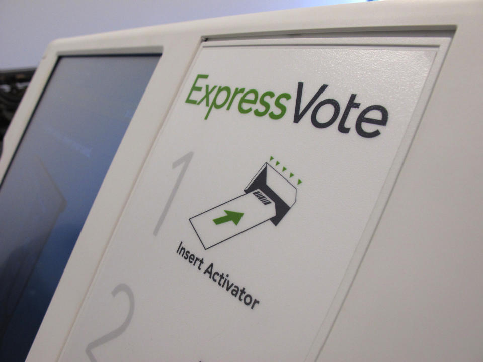 FILE - In this Aug. 16, 2019, file photo, a digital voting machine sits on a table in Raleigh, N.C. North Carolina. In the rush to find reliable new voting machines, many state and local officials are turning to pricey models that some computer security experts see as risky. Called ballot-marking devices, the machines have touchscreens for registering voter choice. (AP Photo/Allen G. Breed, File)