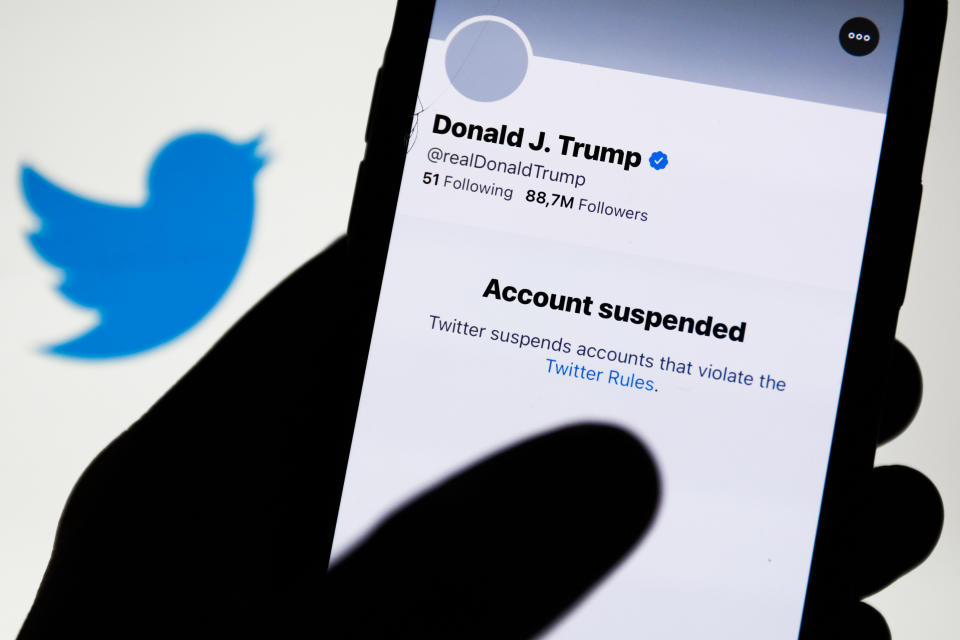 Donald Trump's Twitter account displayed on a phone screen and Twitter logo in the background are seen in this illustration photo taken in Poland on January 9, 2021. Twitter suspended Donald Trump's account because of violating the app rules. (Photo by Jakub Porzycki/NurPhoto via Getty Images)